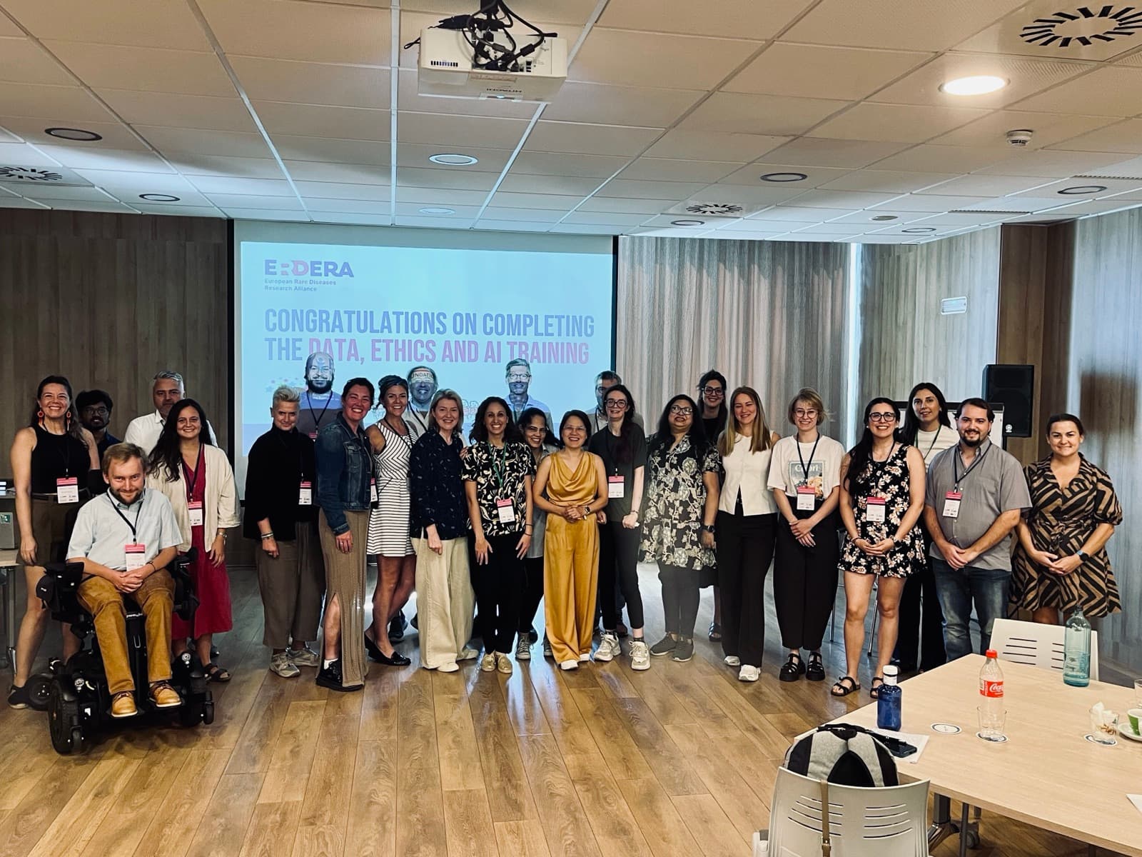 Participants and speakers at the Data, Ethics and AI training in Barcelona, in front of a slide congratulating them on completing the course
